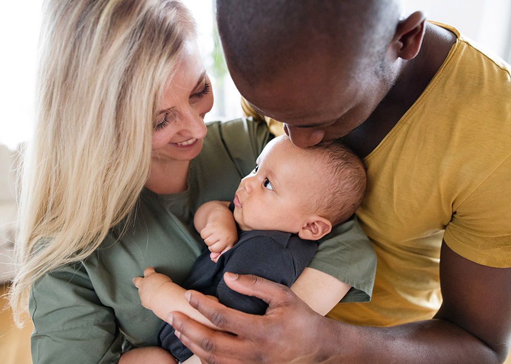 Pro-Life Catholic Health Care. Family Holding baby