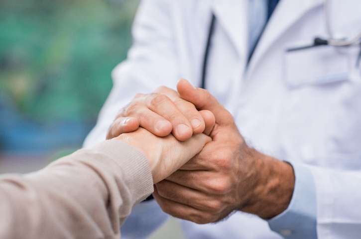 doctor holding patient's hand