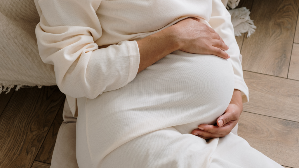 Pregnant woman clutching belly